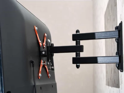 Back view of a wall-mounted flat-screen TV with an adjustable black and orange bracket.||