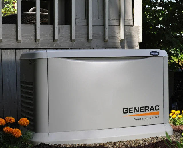 Generac generator installed next to deck.
